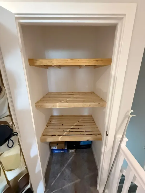 Timber shelving fitted around a cupboard